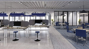 Epsilon Conference Armchair with Sled Base in Blue Finish with Black Table Lamp with Wooden Top Round Table in Breakout Setting