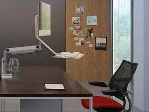 Humanscale Quickstand Lite Desk Converter For Hot Desking 8 In Silver With White Trim On Wood Top Desk With Red Seat Chair