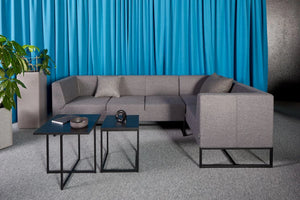 Quick Square Reception Table in Black with Grey Sofa and Grey Acoustic Planter in Living Room Setting