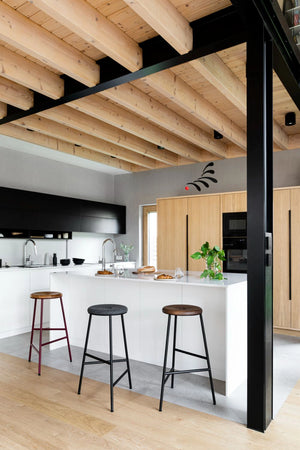 Rotor Upholstered and Wooden Bar Stools with White Counter Top in Modern Kitchen Setting