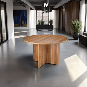 Round Wooden Meeting Table with Indoor Plant and Credenza Unit in Modern Office Setting