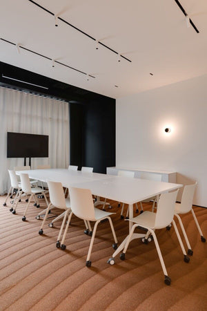Shila A Frame Multitasking Chairs with Castor Wheels with Meeting Room Table in Modern Office Setting