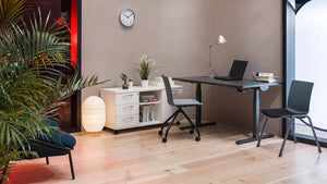 Shila Multitasking Chair with Trestle Base on Castors with Sit Stand Desk and Credenza Unit in Modern Office Setting