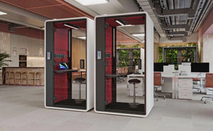 Smart Office Hush Free S Acoustic Phonebooth in White with Red Interior with Black Top Table and Black Movement Stool in Modern Office Setting