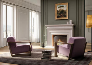 Arco Upholstered Armchair In Light Pink With Stacks Of Books Infront Of Fireplace