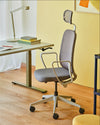 Astro Mesh Task Chair with Headrest with Sit Stand Desk and Table Lamp in Modern Office Setting
