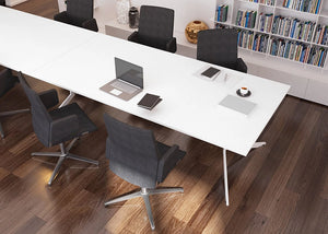 Axy Line Table In White Finish With Upholstered Office Chair Aand Bookshelves In Meeting Room Setting