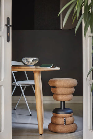 Banffy Height Adjustable Stool in with Coffee Table and Folding Chair in Living Room Setting