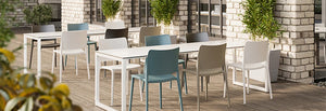 City Outdoor Dining Table In White Finish With Blue Dining Chair And White Pot In Cafeteria Setting