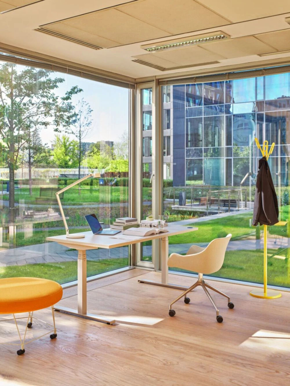 Clip Steel Coat Stand in Yellow Finish with White Sit stand Desk and White Armchair in Modern Executive Office Setting