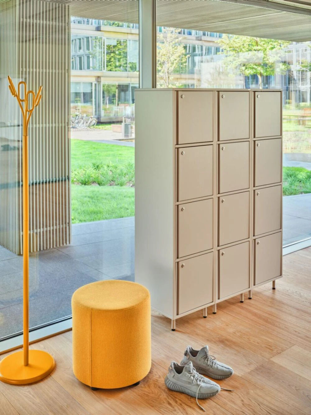 Clip Steel Coat Stand in Yellow Finish with Yellow Pouffe and Beige Lockers