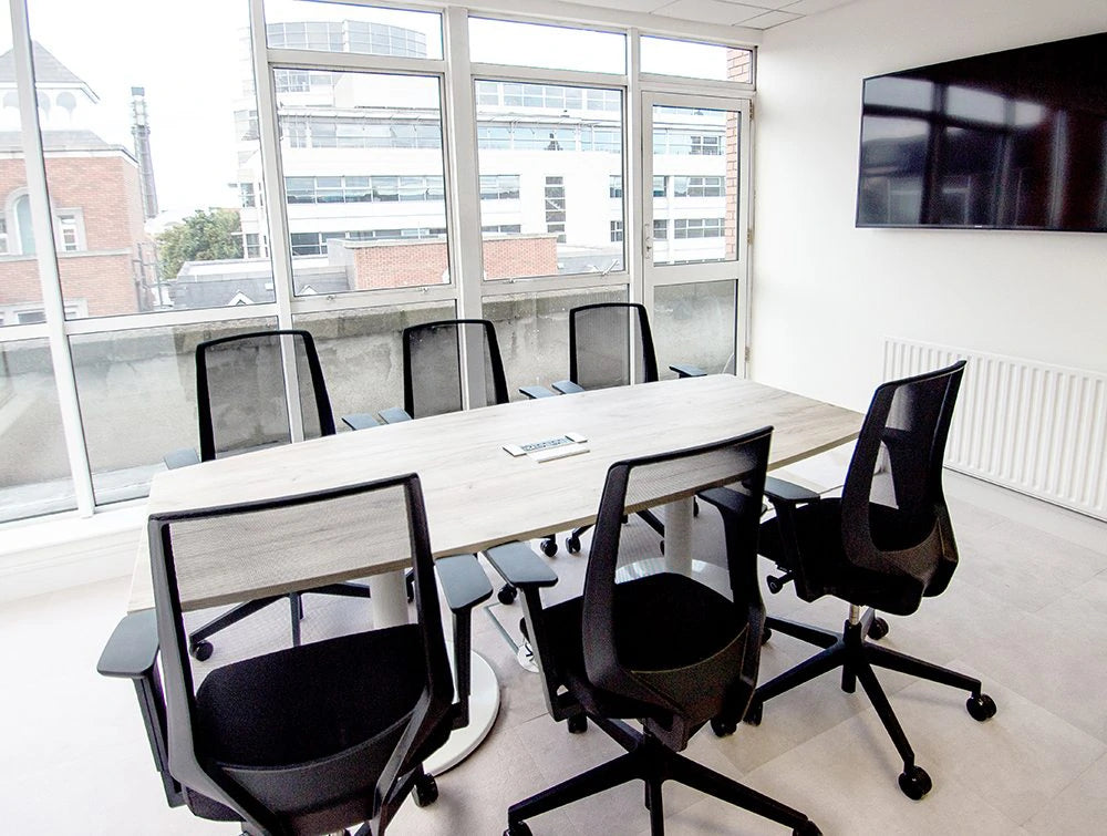 Conference Room With Mesh Chairs And Tv Screen Embedded On Wall