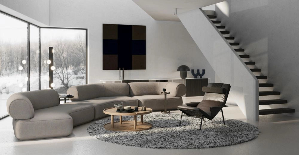 Daaz Modular Seating in Different Configurations with Round Coffee Table and Black Leather Armchair in Living Area Setting