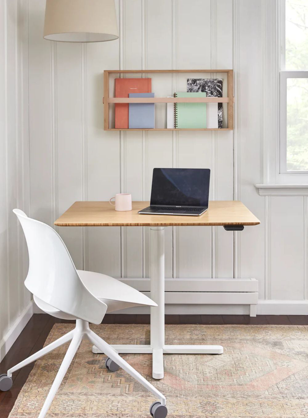 Efloat One Home Office Sit Stand Desk With Wooden Shelves And Mobile Tub Chair In Bedroom Setting