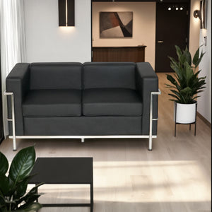 Elite Black Faux Leather 2 Seater Sofa in Lounge Setting