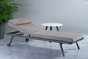 Etesian Outdoor Sun Lounger With Coffee Table And Indoor Plant In Studio Setting