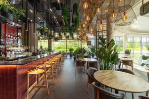 Evo Wooden Highstool with Indoor Plants and Wooden Table in Restaurant Setting