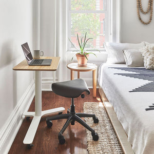 Float Mini Home Office Sit Stand Desk With Coffee Table And Indoor Plant In Bedroom Setting