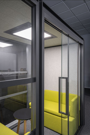 Hako Acoustic Booth with Modular Seating and Round Coffee Table in Breakout Setting