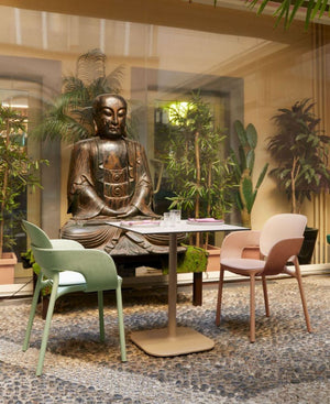 Hug Padded Armchair With Buddha Statue And Indoor Plant In Reception Setting