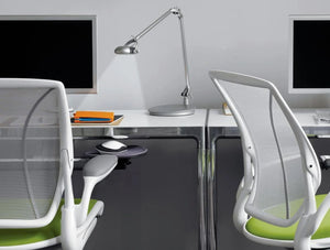 Humanscale Ergonomic And Dimmable Element 790 Desk Light 7 In Silver On White Top Table With Mesh Chair In Office Area