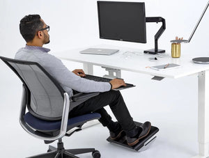 Humanscale Fr500 Ergonomic Foot Rocker With Graceful Curvature 6 In Black Under White Table In Office