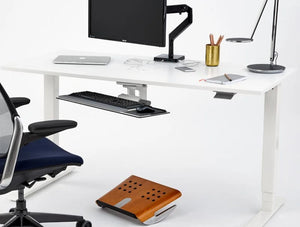 Humanscale Fr500 Ergonomic Foot Rocker With Graceful Curvature 7 In Brown Under White Desk Table In Office Setup