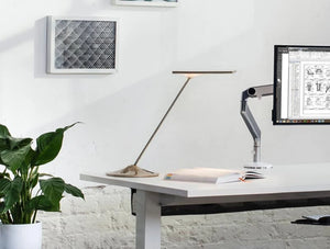 Humanscale Horizon 2 Adjustable Desk Light With Touch Dimming Feature In Bronze Gold On White Desk With Single Monitor