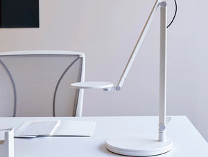 Humanscale Nova Adjustable Desk Light With Charging Desktop Base 7 In White On White Table With White Chair