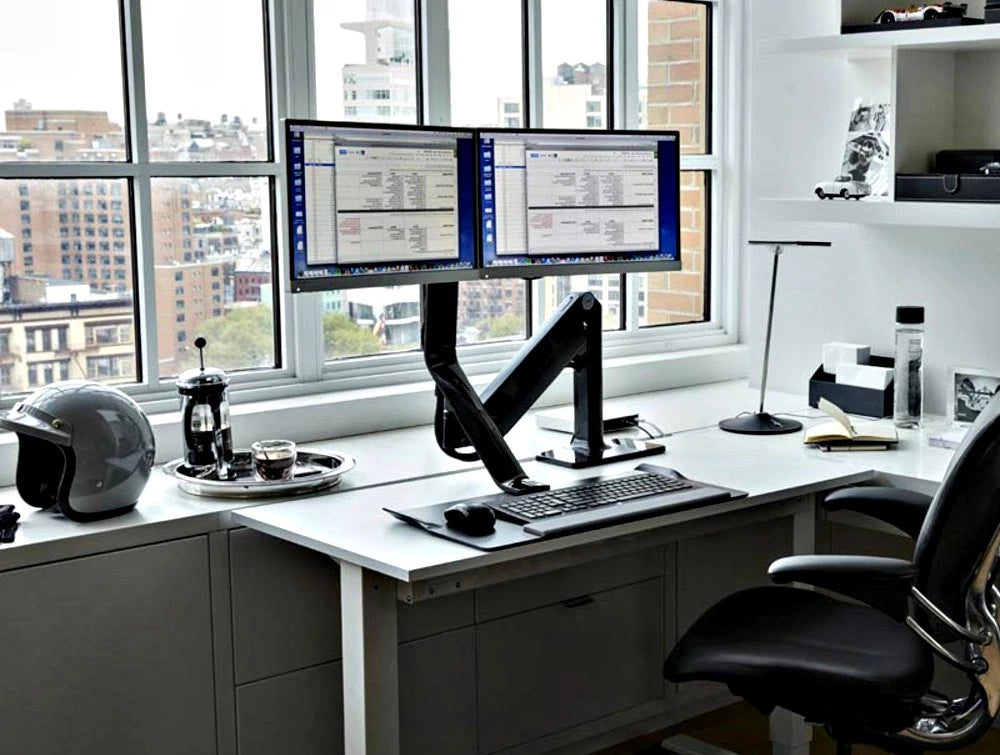 Humanscale Quickstand Lite Desk Converter For Hot Desking 7 In Black With Black Trim With Dual Monitor And Black Chair On White Table