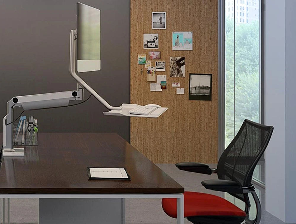 Humanscale Quickstand Lite Desk Converter For Hot Desking 8 In Silver With White Trim On Wood Top Desk With Red Seat Chair