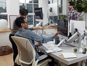 Humanscale Quickstand Lite Desk Converter For Hot Desking 9 In Silver With White Trim With White Swivel Chair