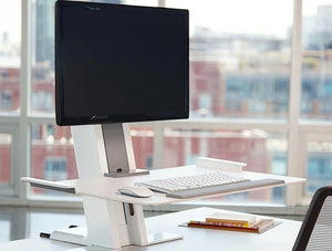 Humanscale Quickstand Sit To Easy And Portable Desk Converter 7 In White With Single Monitor And White Computer Accessories On White Desk