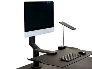 Humanscale Quickstand Under Desk Computer Stand Converter 2 In Black With Black Keyboard On Black Table