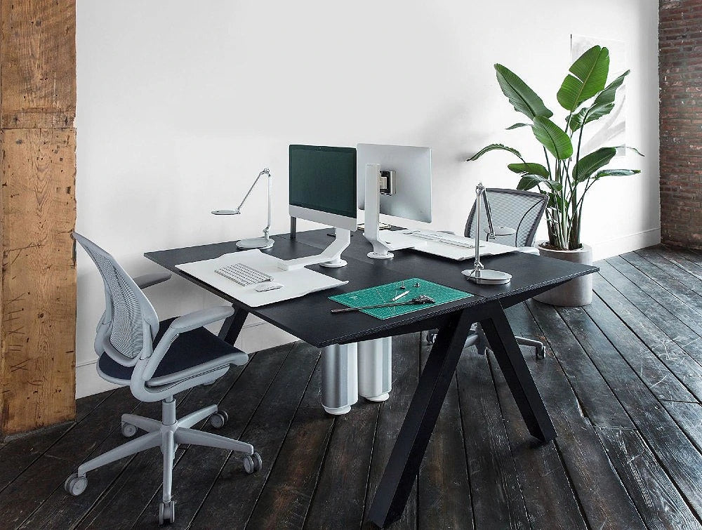 Humanscale Quickstand Under Desk Computer Stand Converter 5 In White With Gray Chair On Black Table