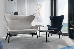 Kate Moodlii Upholstered Armchair In Blue Finish With Black Round Coffee Table In Office Setting
