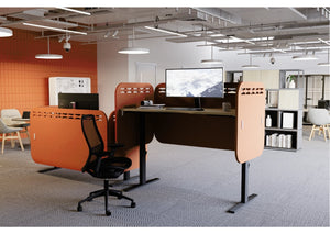 Koala Sit-Stand Acoustic Desk Screen in Terracotta Finish Attached to Sit-Stand Desk with Black Mesh Back Chair in Modern Office Setting