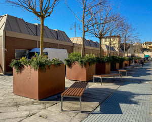 Leman Wooden Backless Outdoor Bench in Brown Finish with Planters in Outdoor Setting 2