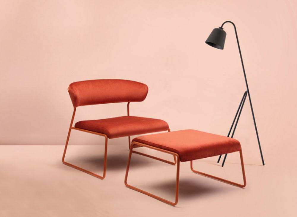 Lisa Lounge Armchair With Pouffe And Floor Lamp In Studio Setting