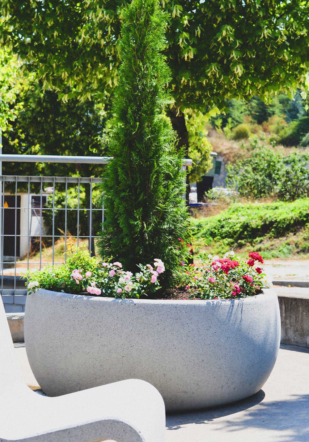 Lisa Medium Outdoor Planter with High Back Chair in Outdoor Setting