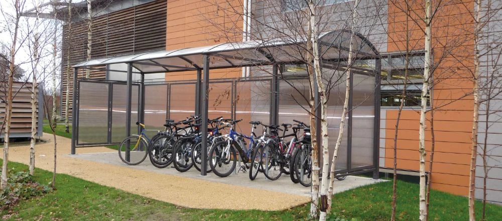 M Barrel Roof Bicycle Shelter with Extension and Back and Side Cladding 4 with Bicycles in Outdoor Setting
