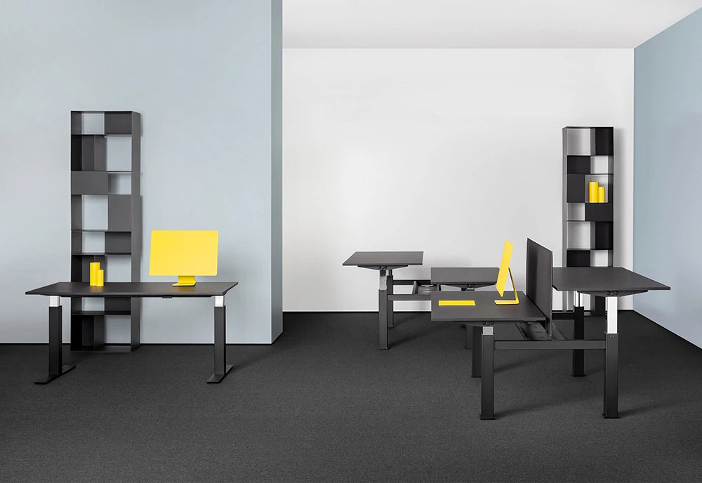 Mara Follow Height Adjustable Office Bench Desk In Black Finish With Grey Shelves In Office Setting