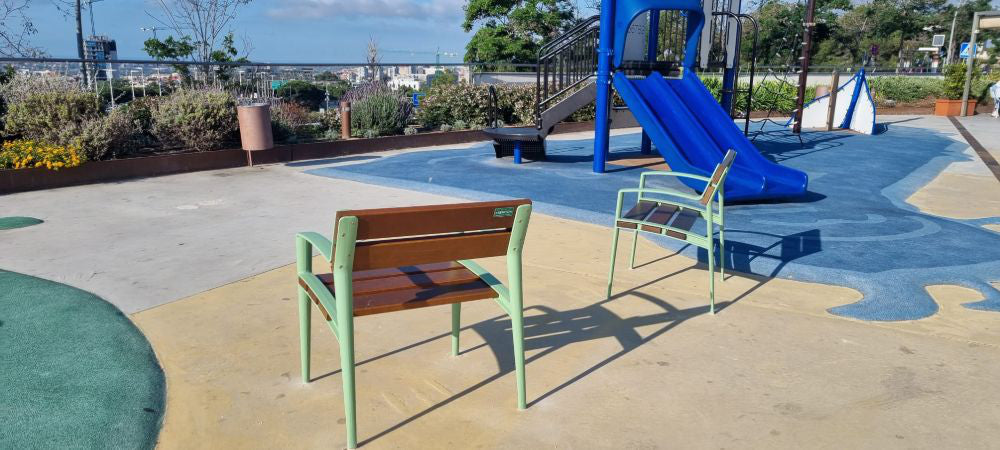 Minsk Wooden Outdoor Chair with Green Finish Armrests in Outdoor Setting 3