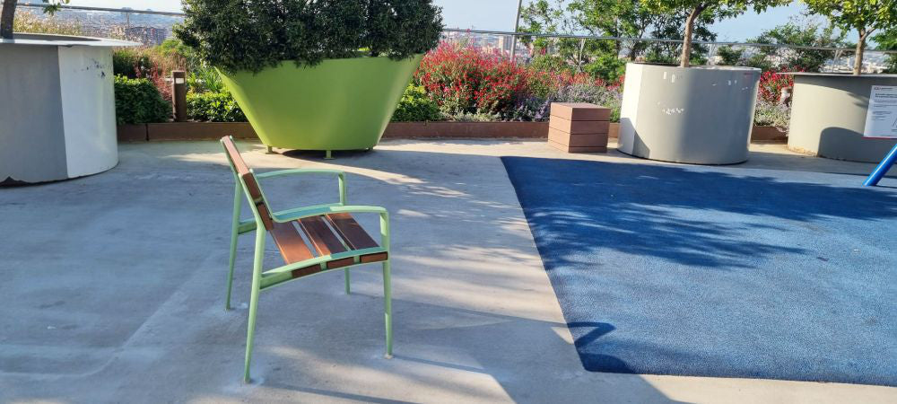 Minsk Wooden Outdoor Chair with Green Finish Armrests in Outdoor Setting