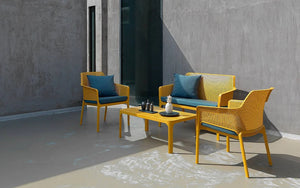 Nardi Net Coffee Table in Mustard with Matching Armchair and Sofa with Cushion in Outdoor Setting