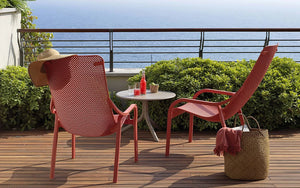 Nardi Net Stackable Monobloc Lounge Armchair in Coral with Small Round Table in View Deck