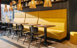 Nova Dining Table In Light Oak Finish With Pendant Light And Yellow Modular Sofa In Restaurant Setting