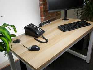 Orion On Desk Power Module With 2X Power And 2X Data Black 17 On Top Of Wooden Table With Telephone