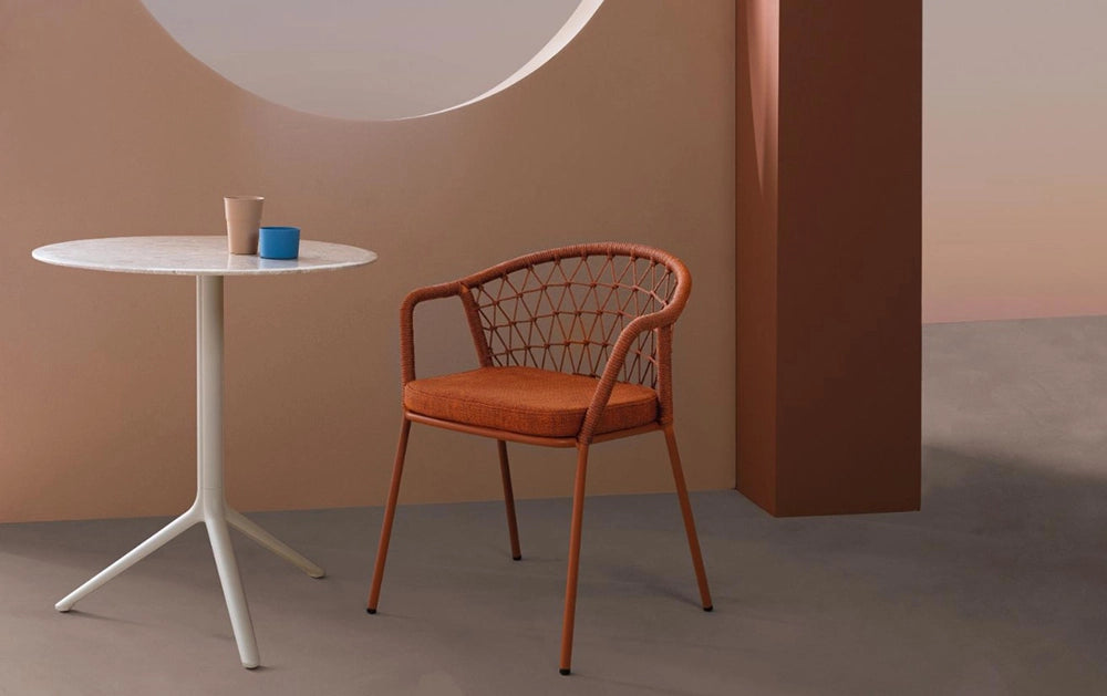 Panarea Dining Chair with Armrests in Brown Finish with Round Table in Studio Setting 2