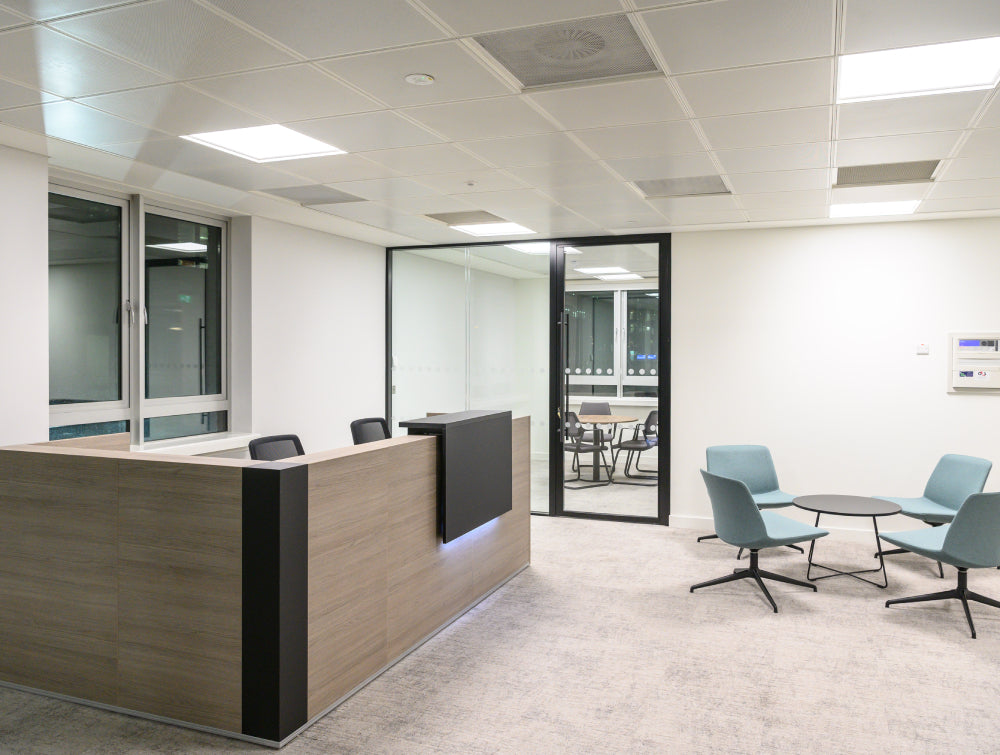 Reception Counter With Round Coffee Table And Lounge Chair In Reception Setting